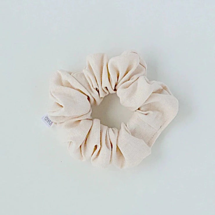 Cream linen hair scrunchie. Classic linen hair scrunchies are handmade by Siena Vida, a women founded company in Ontario, Canada with a goal of transforming hair accessories to being more environmentally friendly & durable.  Vanessa the founder, sources sustainable fabric for her hair scrunchies from local, women led businesses that produce high quality, long lasting material.