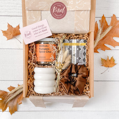 Autumn self care gift box by The Kind Curator Co. Includes local, Canadian products; seasonal tea such as Pumpkin Spice Chai, pumpkin spice soy wax candle, espresso silk hair scrunchie, chocolate bar.