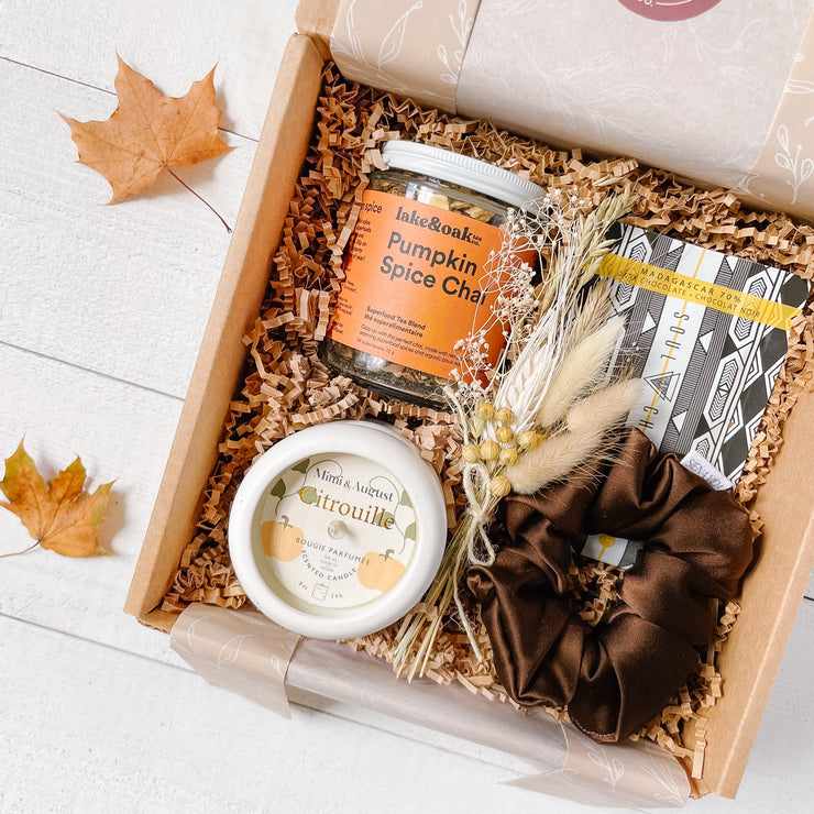 Autumn self care gift box by The Kind Curator Co. Includes local, Canadian products; seasonal tea such as Pumpkin Spice Chai, pumpkin spice soy wax candle, espresso silk hair scrunchie, chocolate bar.