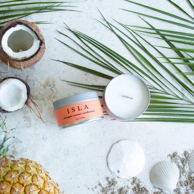 Isla, Coconut soy wax candles with wood wick in travel tins from Brightfield, a woman owned business in Toronto, Ontario. Hand-poured with love in small batches from our studio in The Beach, Toronto. With notes of pineapple, coconut and vanilla musk.