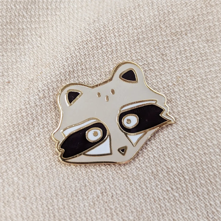 Mont-Royal Raccoon Enamel Pin from Mimi & August in Montreal, Quebec, a woman owned company.  If you've ever visited Mont-Royal, you've probably met our raccoon friends. We strongly advise you not to feed them but to appreciate them from afar because they are super cute.
