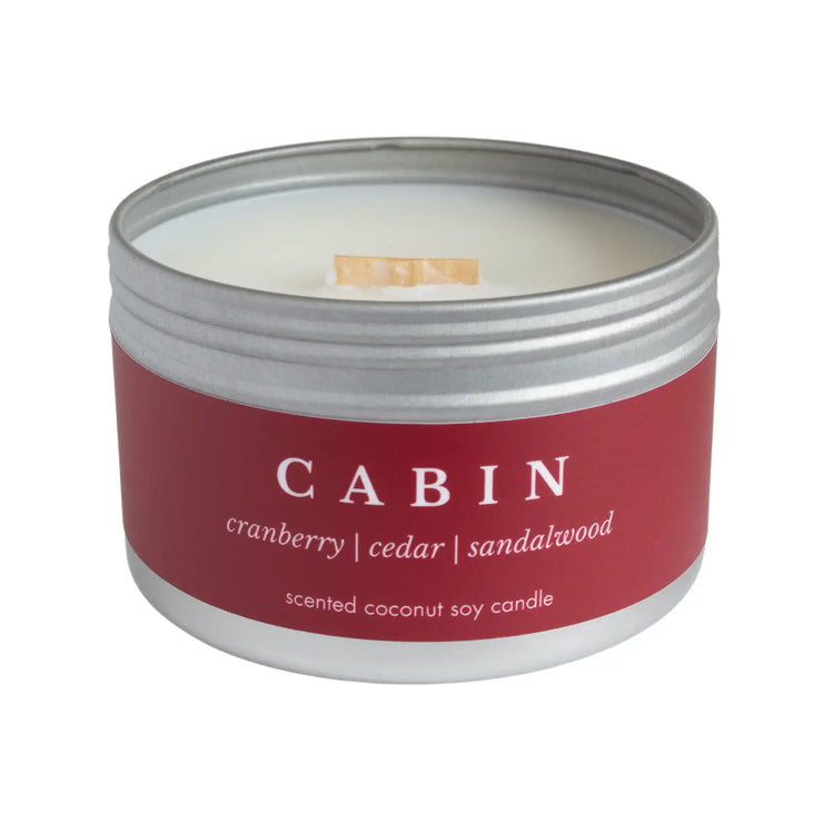 Cabin, non-toxic coconut soy wax candle in a travel tin from Brightfield in Toronto, Ontario. Take a trip to a cozy cabin with this fall and winter scented candle. It has a comforting blend of cranberry, cedar, cinnamon, and sandalwood. Woman owned business.