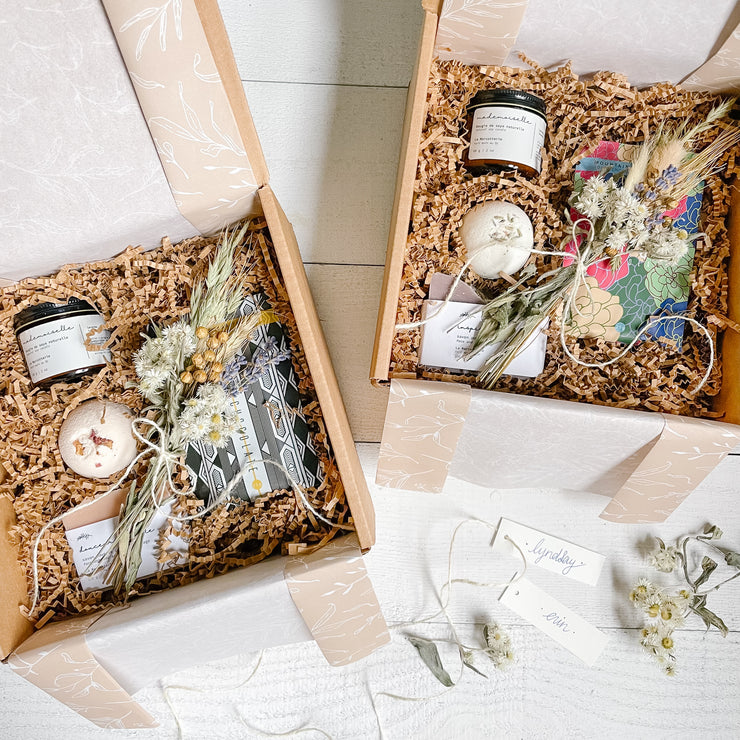 Custom self-care bridal party gift boxes with local, small-batch products. French inspired natural skincare - bath bomb, natural soap bar, soy wax candle and a dark chocolate bar.