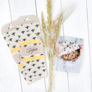 Goldilocks beeswax food wraps set of 3 with bee pattern. Made with love in beautiful British Columbia by Goldilocks, each reusable beeswax wrap is handmade in small batches.  Beeswax food wraps are an all natural, reusable & eco-friendly alternative to plastic wrap and they will even keep your food fresh for longer!  All Goldilocks beeswax is sourced from Canadian bees and beekeepers.