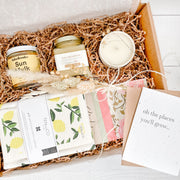 Custom client gift box with local, small-batch products. Ontario creamed honey, turmeric latte mix, soy wax candle in a reusable ceramic pot, beeswax foodwraps, lemon tea towel, lemon Swedish sponge cloth and a plantable greeting card.