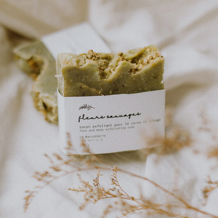 Wild Flowers natural french inspired soap bar from La Marcotterie, Quebec, Canada. This cleansing and exfoliating bar of soap contains moisturizing plant butters and oils, essential oils and botanical extracts. The combination of pumice stone and poppy seeds offers a gentle exfoliation, leaving your skin renewed, soft and refreshed, without irritation! With essential oils of frankincense, pine scotch, lemongrass and spearmint.