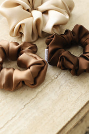 Silk hair scrunchies in champagne, espresso, nutmeg. Classic silk scrunchies are made of 100% silk from up-cycled Italian silk sourced from the Toronto Fashion District. Deadstock that would have otherwise ended up in the trash! Silk is very gentle on your hair! All hair scrunchies are handmade by Siena Vida, a women founded company in Toronto, Canada with a goal of transforming hair accessories to being more environmentally friendly & durable.