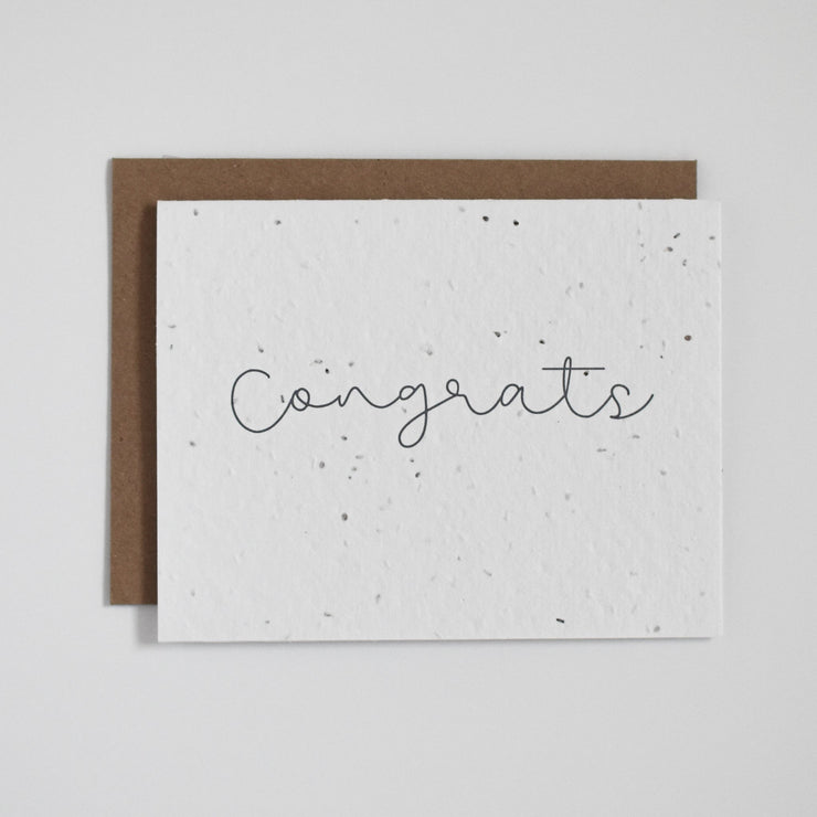 "Congrats". Our plantable greeting cards are designed and printed in Guelph, Ontario by The Good Card. Their paper is all Canadian made. Kind words that come with a little something extra - flowers!  Plantable seed paper cards are made from bio-degradable, post-consumer waste meaning no new trees are harmed. Each card is full of a blend of 6 different wildflower seeds, that are all tested for purity, non-GMO, and non-invasive. All cards are printed with non-toxic ink